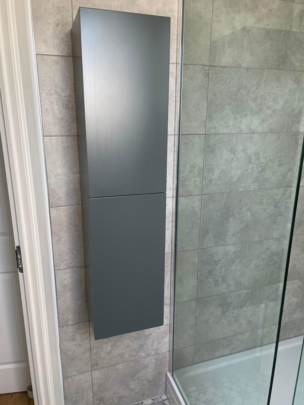 New shower and wall mounted storage unit installed in a new bathroom suite in Alvechurch.
