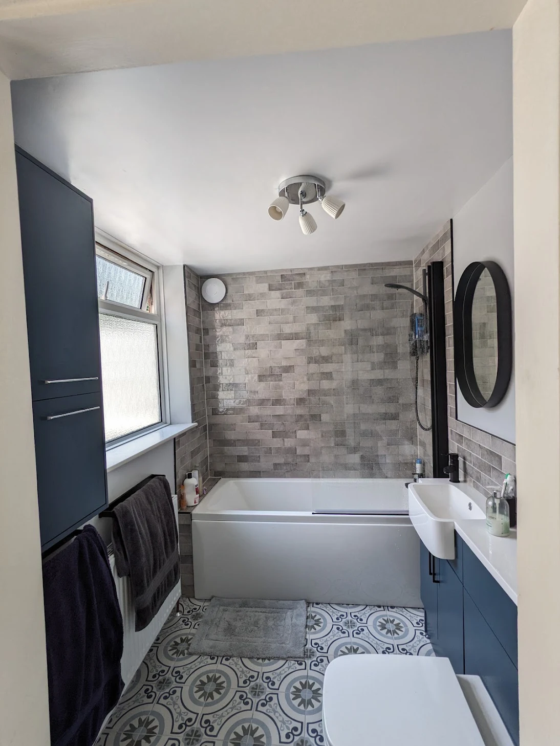 New bathroom installation in Harborne. New vanity unit with combined sink, toilet and storage. New bath and floor to ceiling tiling.